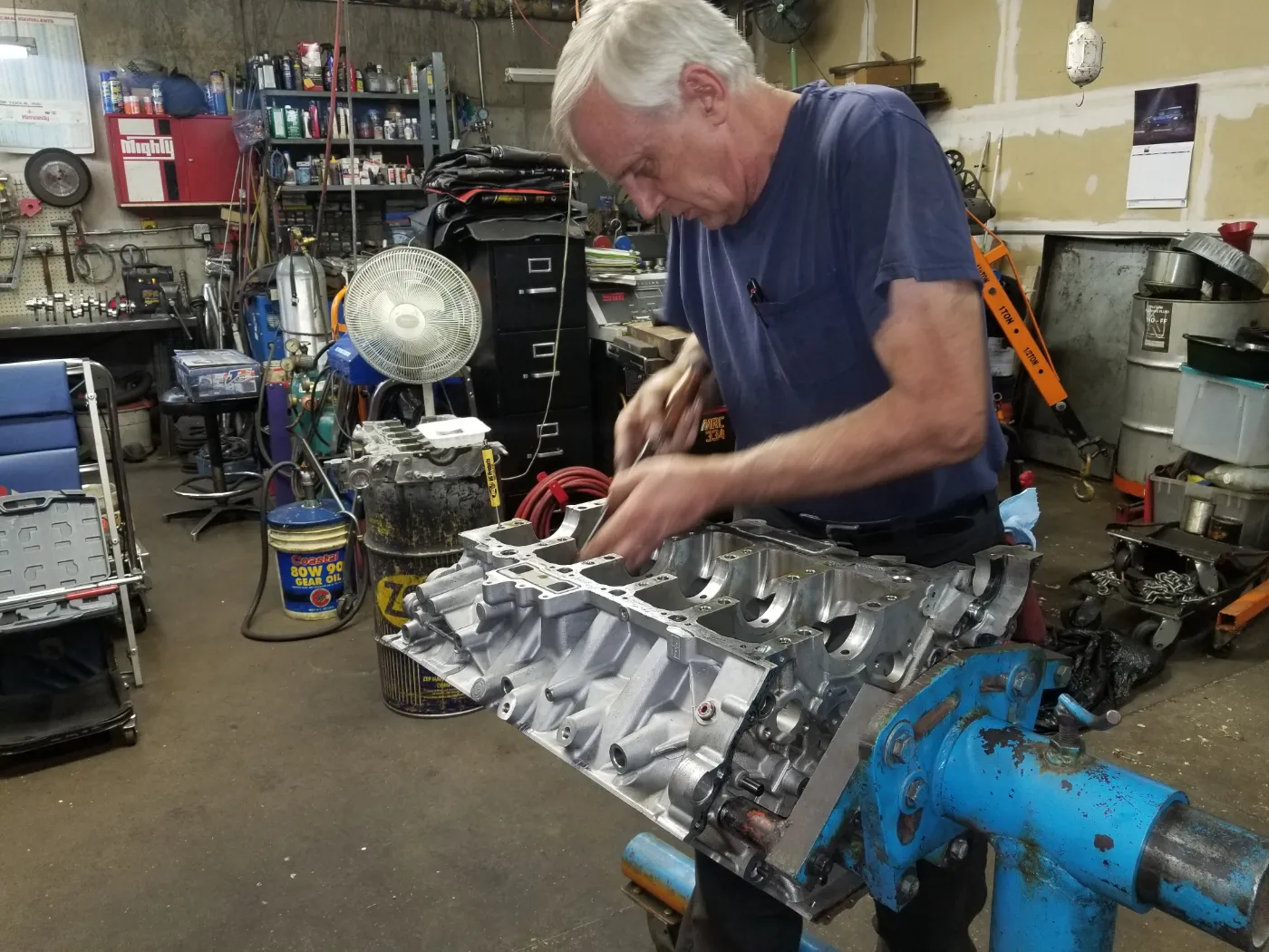 Ed at the bench in the shop working on a bare aluminium engine block